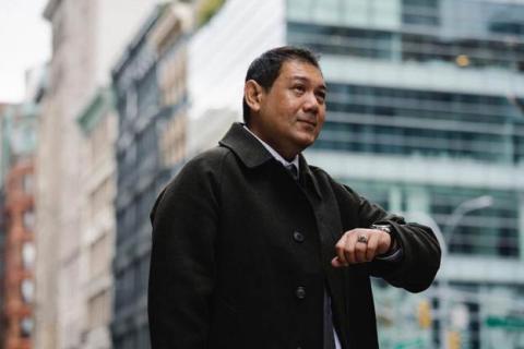 A man impatiently looking at his watch